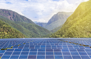 solar photovoltaics panels in solar power station  with mountains  background