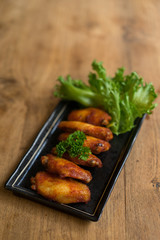 chicken wing new orleans yummy on square dish and wooden table.S
