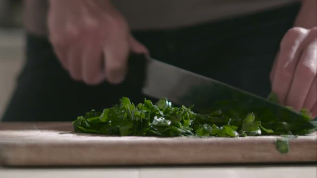 Woman prepares salad on the cutting board