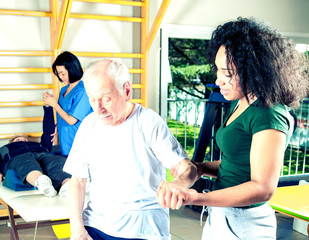 Elder people making exercises in a rehab clinic for ritired