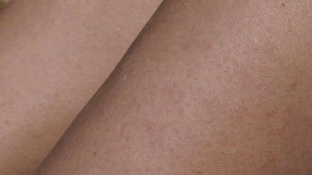 Texture of female skin highly detailed close-up 4K 2160p 30fps UltraHD panning footage - Woman tanned legs after exposing them to sun slow pan 4K 3840X2160 UHD video 