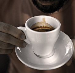 Bearded man drinking coffee espresso