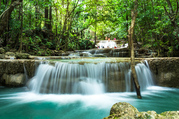 waterfall on day noon light in green tropical forest,