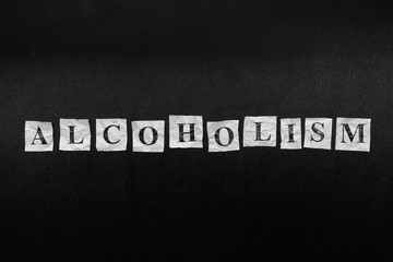 Paper notes with the word Alcoholism
