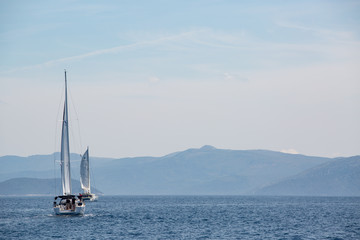 Obraz premium Sailing boat in the adriatic ocean, Croatia. Mountains on the horizon.