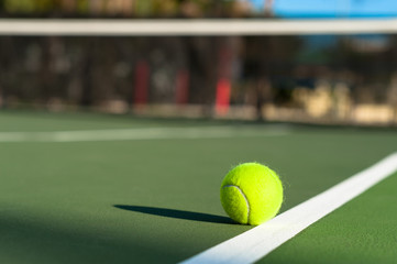 Tennis ball on court baseline