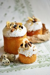 Easter holiday cake with quail eggs nuts dried fruits on white tablecloth