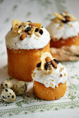 Easter holiday cake with quail eggs nuts dried fruits on white tablecloth