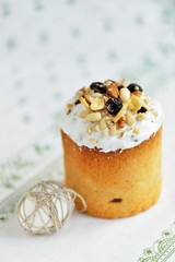 Easter holiday cake with eggs nuts dried fruits on white tablecloth