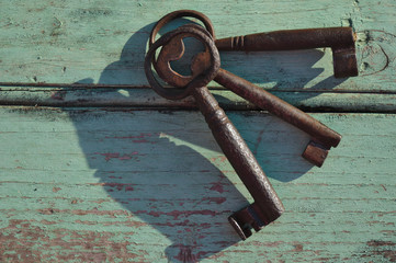 Skeleton keys on top of an old wooden surface. Backgrounds and textures
