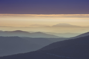 Lines of beautiful mountains in fog