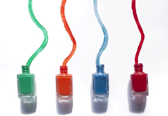 Colored nail polishes on white background