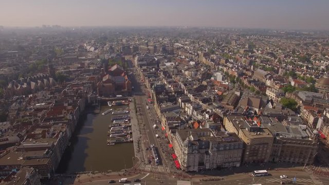 Amsterdam aerial sightseeing. Flying above old centre district. 4K
