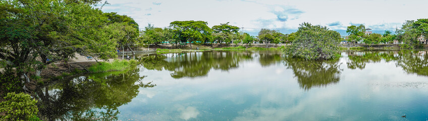 panoramic photo of a lake and the surrounding greenery