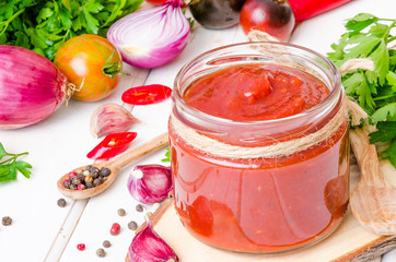 homemade spicy tomato sauce or ketchup on a white background