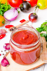 homemade spicy tomato sauce or ketchup on a white background