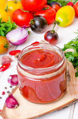 homemade spicy tomato sauce or ketchup on a white background