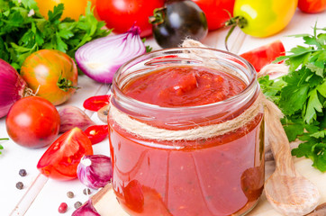 homemade spicy tomato sauce or ketchup on a white background