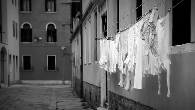 Black and white footage: laundry is drying on the streets on Venice