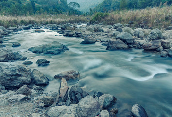 River water flowing through rocks at dawn, Sikkim, India
