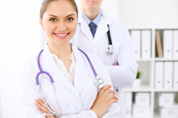 Fototapeta premium Happy doctor woman with medical staff at the hospital