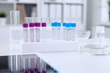 Research laboratory working space. Test tubes and tablet PC are lying at the table. Medical equipment. Blood test