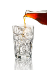 Cola pouring in a glass on white background