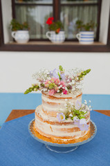 naked wedding cake with flowers
