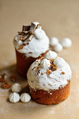 Easter holiday cake kulich with cream nuts dried fruits chocolate cookies marshmallows on craft background