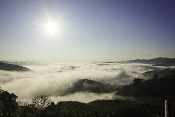 mist, sun, sky and mountain