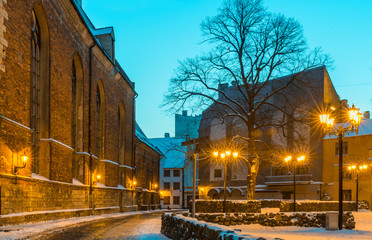 Fototapeta na wymiar Old Riga city by winter night. Riga is a famous European tourist city with unique medieval and Gothic architecture