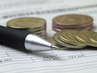bill, pen and coins for payment, macro, shallow depth of field