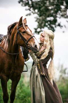 Elf woman in the forest with a horse