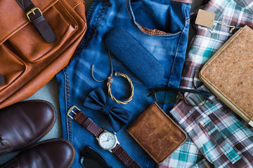 Flat lay of men's casual outfits with accessories on gray background