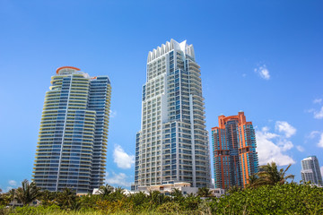 Fototapeta na wymiar Miami skyscrapers. Miami South Beach in Downtown District in sunny day. Apartment and business buildings in Miami Beach, Florida.