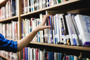 library, hand reaching for book