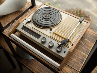 The old broken white and brown wooden with plastic turntable