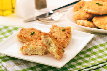 Roasted chicken cutlets with garlic and cheese on white plate.Selective focus.