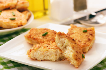 Roasted chicken cutlets with garlic and cheese on white plate.Selective focus.