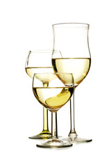 Three different glasses with white wine isolated on a white background