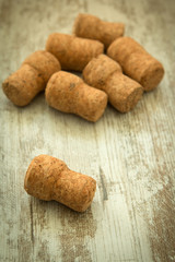 Corks from a champagne bottle on a wooden background