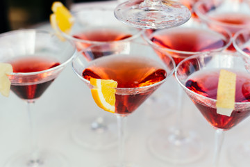 Glasses with Martini garnished  a slice of orange.