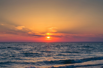 Beautiful sunset over the Black Sea in the summer.The bird flying over water. Sea landscape. Nature composition