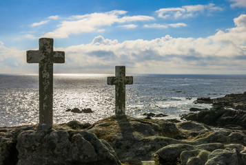 Stone cross monuments by the sea in late afternoon, Costa da Morte, Galicia