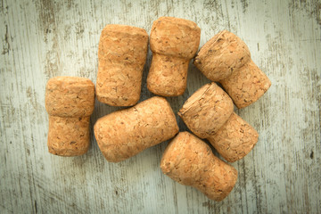 Corks from a champagne bottle on a wooden background