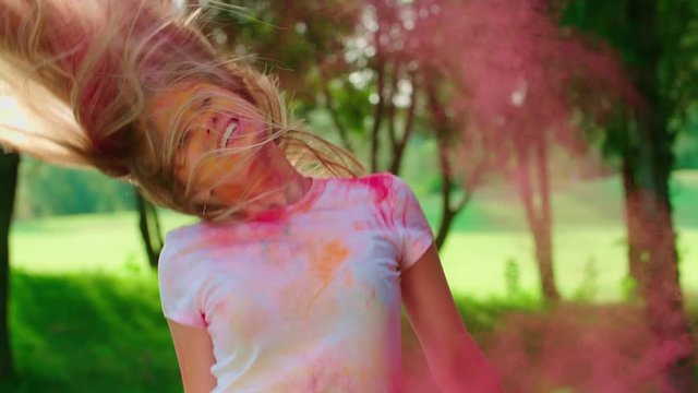 close-up, European young beautiful girls having fun in the Park with the colors of Holi,slow motion