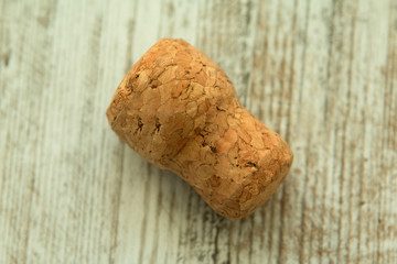 Cork from a champagne bottle on a wooden background