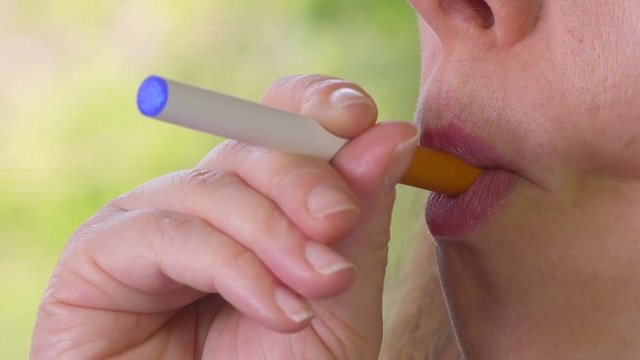 Woman Smoking E-Cigarette and Coughing Side View 