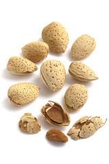 Almonds with kernels on white background