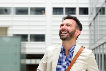 Cheerful older man laughing outdoor